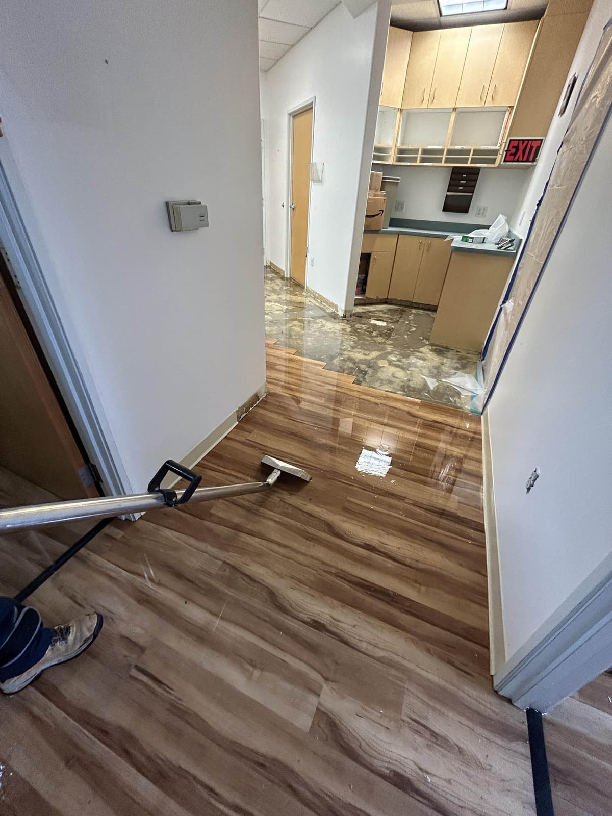 Extracting standing water from a flooded hallway floor